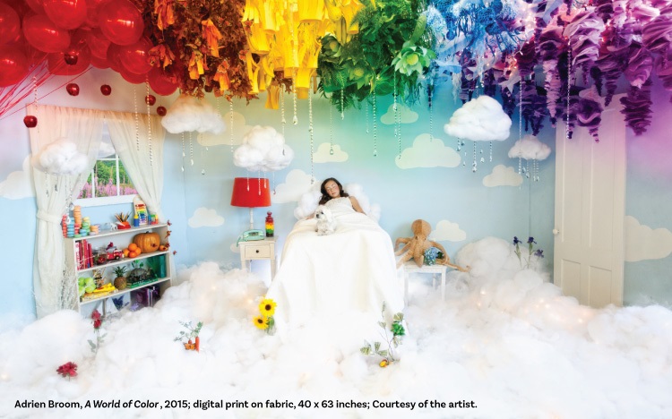 Image of girl sleeping in a white bed with rainbow of colors above her head