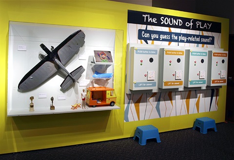 giant airplane toy on the left and boxes with speakers and playful sounds on the right