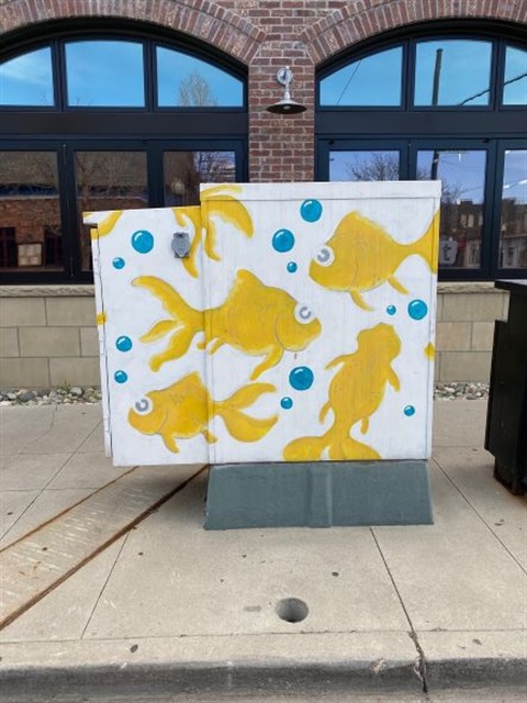 Traffic box painted with yellow goldfish
