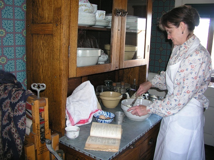 Interior shot of person working in 1890s kitchen
