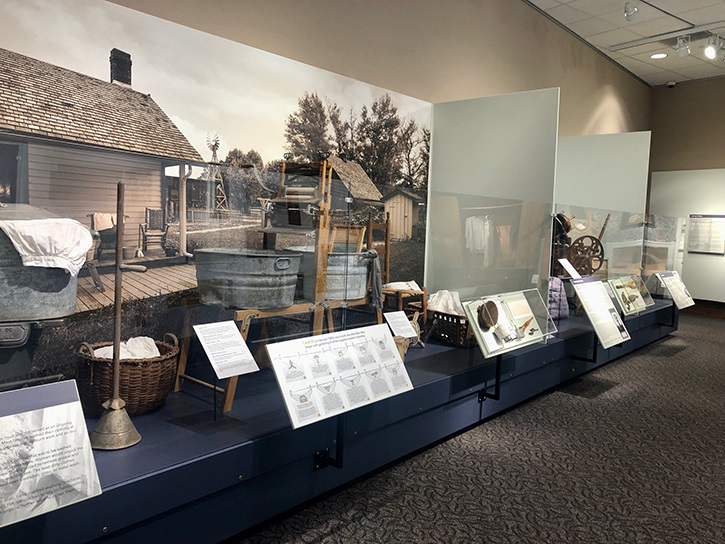 Image of an exhibit display with 19th century washing utensils and equipment