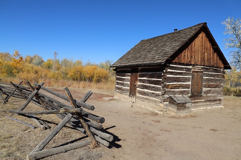 Exterior of one-room schoolhouse built with wooden logs