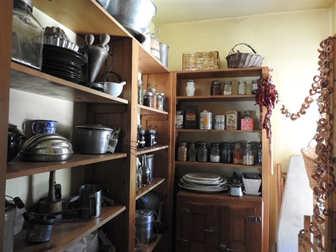 interior of a small pantry with dishes and dry goods