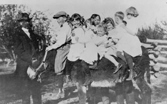 Littleton children ride on a donkey at Gallup Lake, c.1910-11. Left to right: Charlie Bowles, unidentified Bowles boy, Dorothy Gallup, unidentified, Perry Gallup, Lucy Gallup, Charlotte Gallup, Bill Caley (?), Rosalyn Caley.