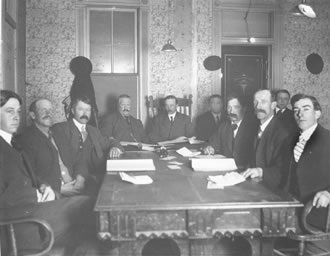 Littleton town council in session, c.1909. Left to right: Frank Lewis — councilman; Fred A. Bemis—councilman; Hugh Shellabarger — councilman; William S. Jull — clerk and recorder; Dr. W. C. Crysler — mayor; Robert Nelson; John Harris — councilman; Charles W. Downing — councilman; William H. Caley — town attorney; Ernest C. Shindorf — councilman.