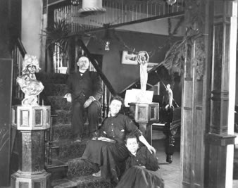 Samuel T. Culp and two of his daughters, Adelaide (middle) and Cecelia (bottom) on the main staircase of the Culp House, c.1906. Behind them is the entrance to the parlor.