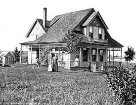 Henry Hargraves Curtis home at 6797 S. Windermere c.1893. The house was built in 1891. The property was homesteaded by Anthony Wyman in 1862 and sold to Henry H. Curtis, Jr. in 1882. The people in this photo are probably (left to right) Henry H. Curtis, Harry, Mabel (Dunn), Rachel (Mrs. Henry H.) Lutz Curtis, Kate (Alexander) on porch, and Maude.
