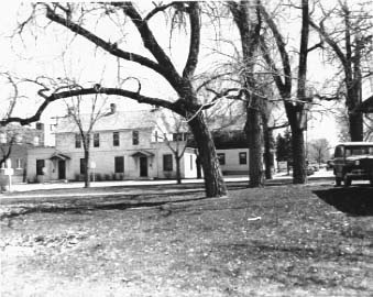 Littleton's first general store, the Julius D. Hill General Store, 5728-38 S. Rapp Street. The building was built in 1872. The four cottonwood trees in the foreground were part of a circle of trees inside the fence of a circular plaza in front of the old Harwood Inn.