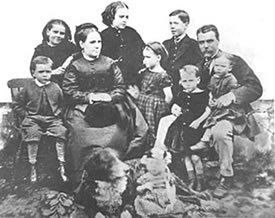 The Ebenezer Jull Family, c.1871. Back row, left to right: Ada, May, Will; center: Tom, Mrs. Ebenezer Jull. At right knee of father is Arthur, Janet sitting on his lap. Sydney Percy Jull is on the floor next to the dog.