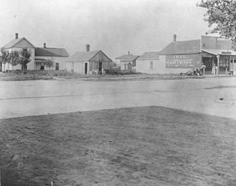 Jull Hardware Store on north side of Main Street, east of Prince, c.1898. Ebenezer Jull is standing at right.