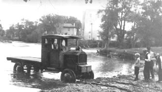 Possibly the first truck made by the Holmes Motor Coompany 1920. Photo looks east from the South Platte River with the Carnegie Library in the background