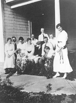 The Weaver family on the porch of the Weaver home at 6556 S. Crocker, c.1917. Left to right, front row: Kathryn, Jack Auping, cousin and child, Helen Weaver MacGregor, cousin (boy in cap), Robert, Mrs. Weaver (mother) and Frieda (next to post). Back row: Morton, George (father), Eldo.